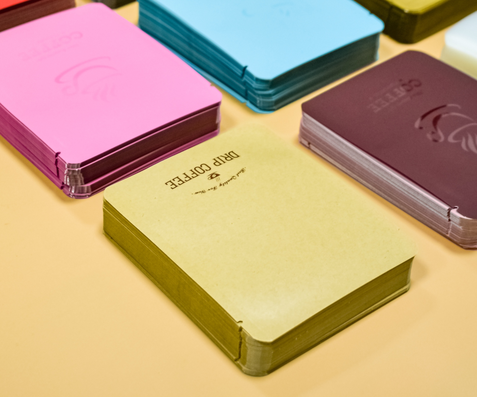 Stacks of colorful rounded drip coffee outer pouches